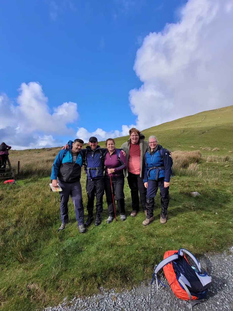 A photo of a group of scout leaders from left to right:
Owain, Richard, Sarah, Ruan, And Lorraine 

The photo is infront of a mountain in wales 