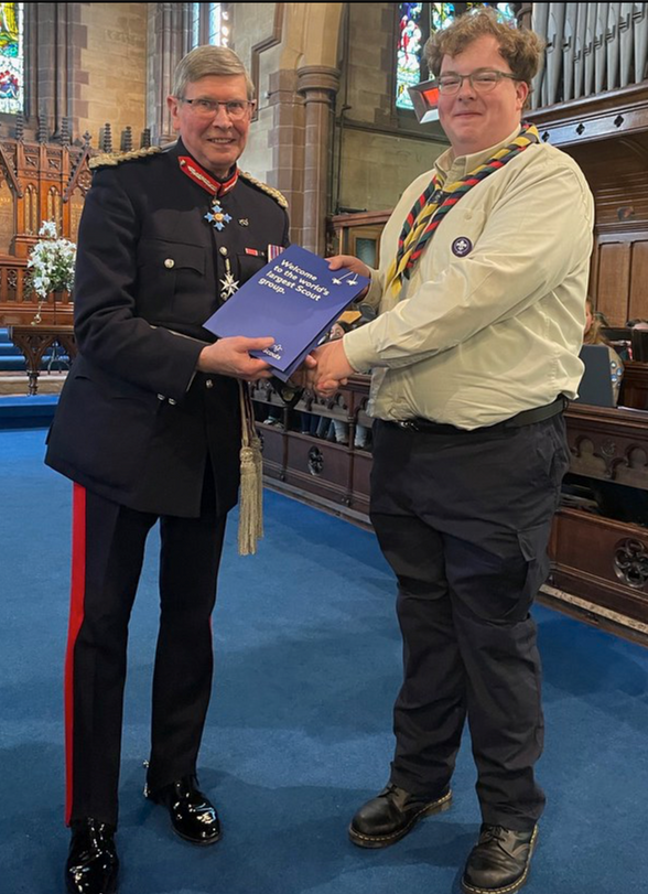 A photo of Ruan - he is in Scout leader uniform reciveing an award from Ian Dudson Lord-Lieutenant of Stafforshire